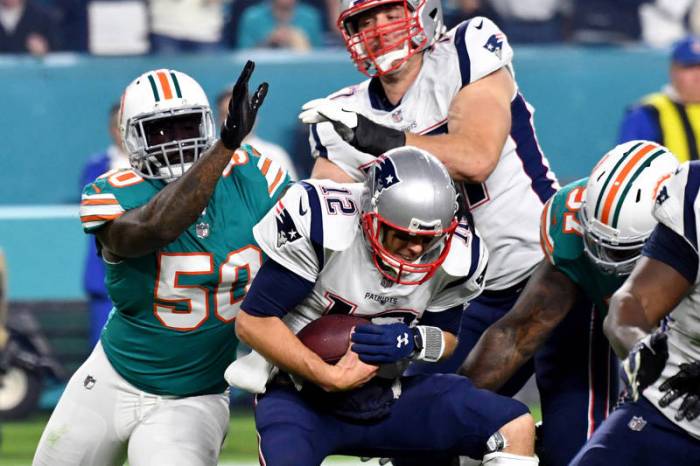 Miami Dolphins strong safety T.J. McDonald (22) defends New England  Patriots wide receiver Danny Amendola (80), as Amendola is unable to hold  onto the ball, during the second half of an NFL