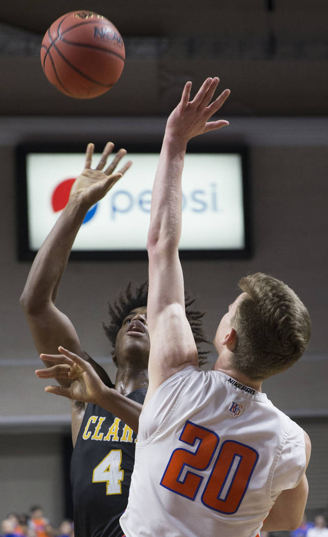 Clark senior guard Carlos Allen (4) shoots a jump shot over Bishop Gorman junior guard Noah Taitz (20) in the third quarter of the Class 4A boys state championship game on Friday, March 1, 2019, a ...