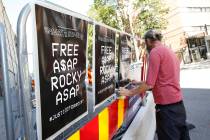 A man displays posters in support of US rapper A$AP Rocky, real name Rakim Mayers, outside the ...