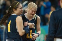 Boulder City’s Jana Williams (11) cries while being helped off the court by teammate K ...