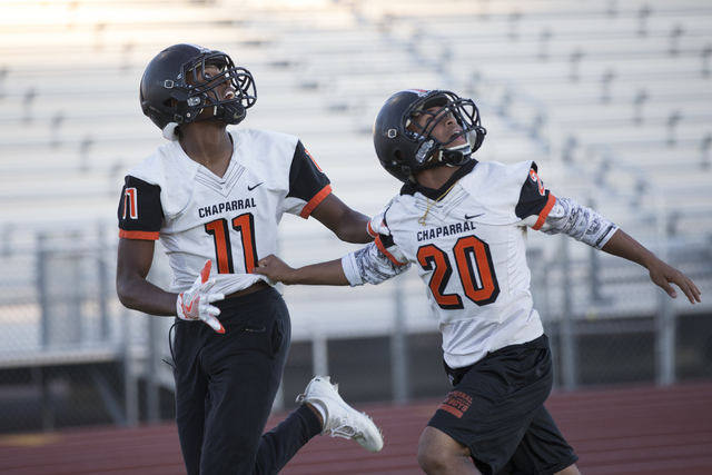 Chaparral’s Kentrell Petite (11) runs a pass drill with Dylan Disroe (20) during pract ...