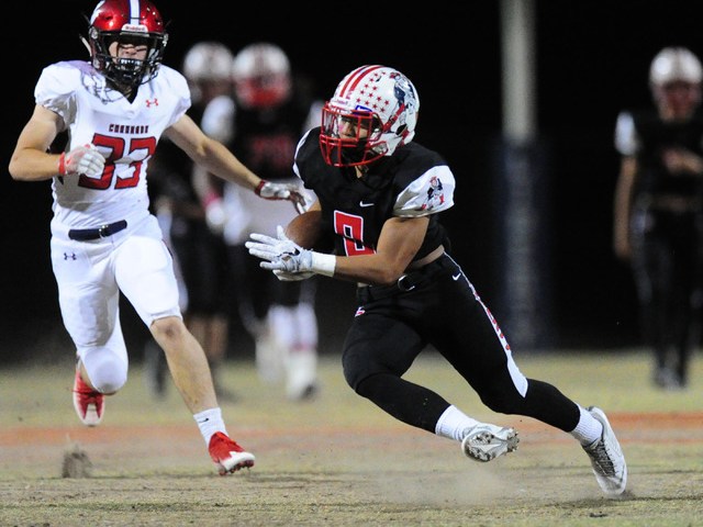 Liberty wide receiver Bryson Delacruz changes direction after catching a first down pass aga ...