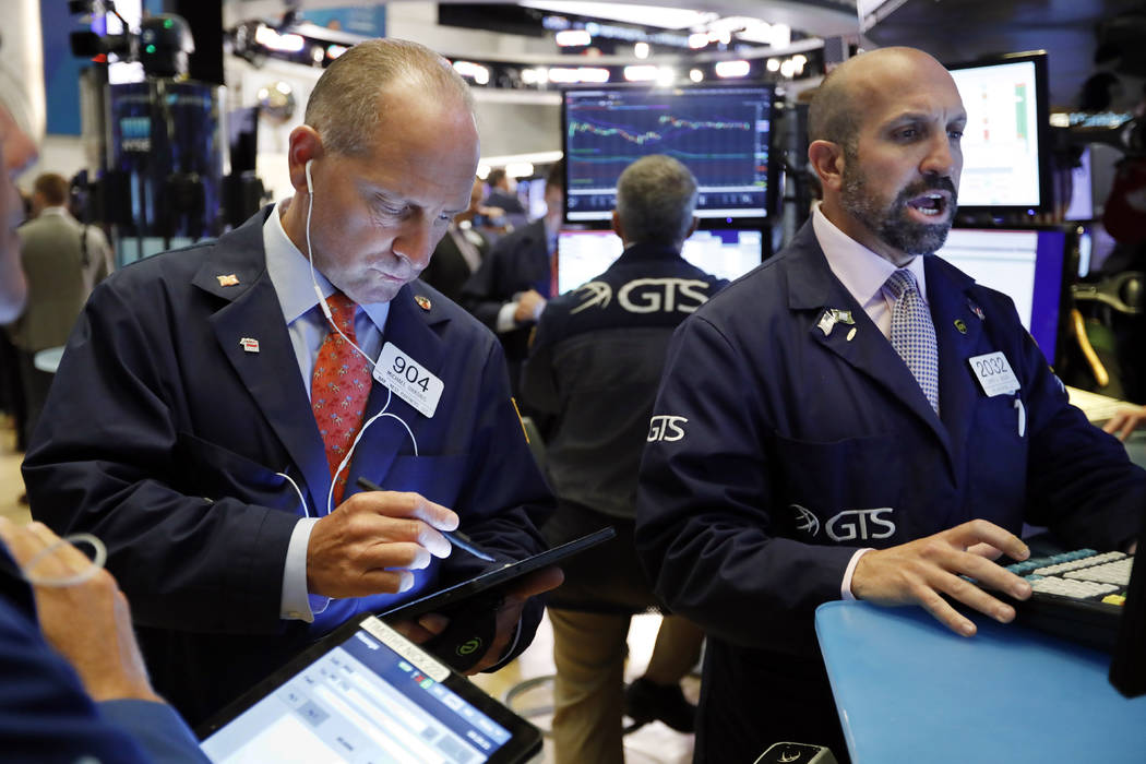 Trader Michael Urkonis, left, and specialist James Denaro work on the floor of the New York Sto ...