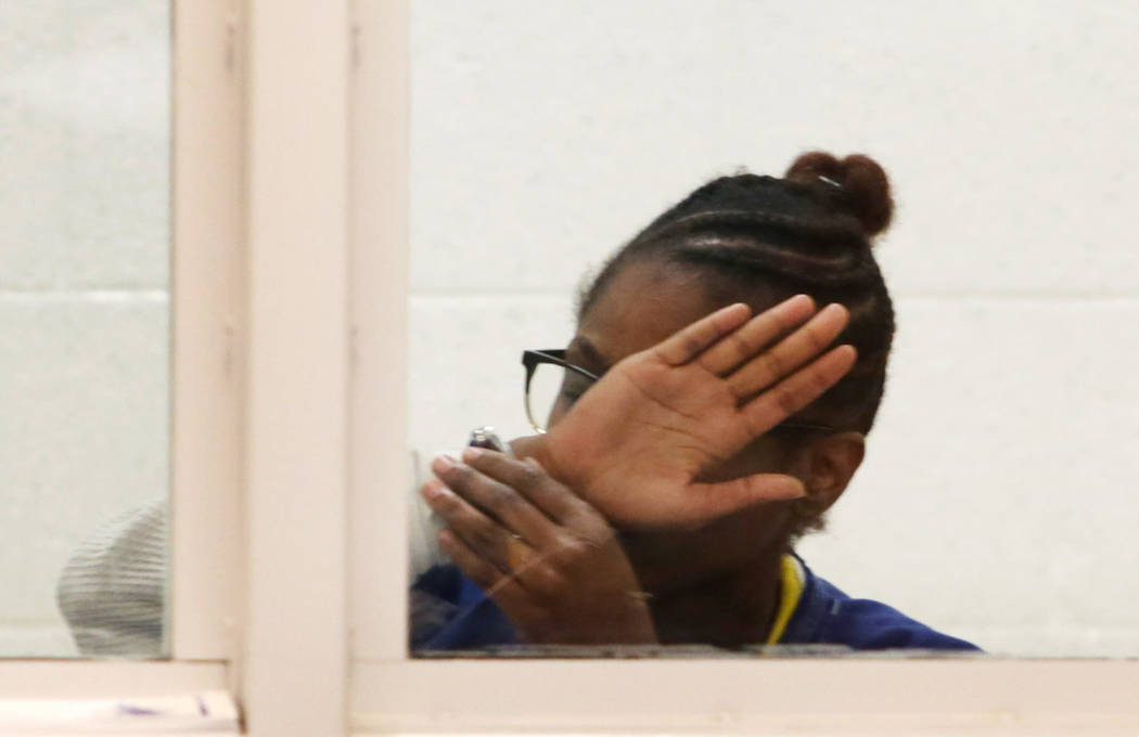Shaniya Poche-Lawton covers her face while appearing in court at the Michael Antonovich Antelop ...