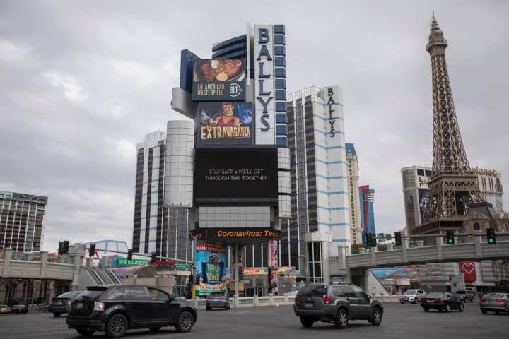 The Bally's marquee shows MGM's message alongside news about coronavirus on the Strip on Wednes ...