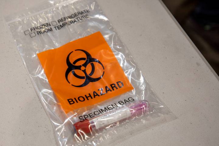 A completed COVID-19 test in a biohazard bag during a preview of COVID-19 testing site at Cashm ...