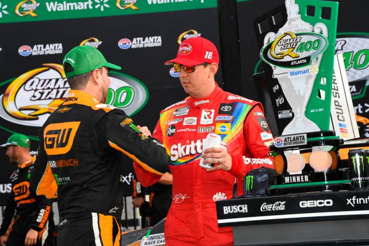 Kurt Busch is congratulated by his brother Kyle Busch after winning a NASCAR Cup Series auto ra ...