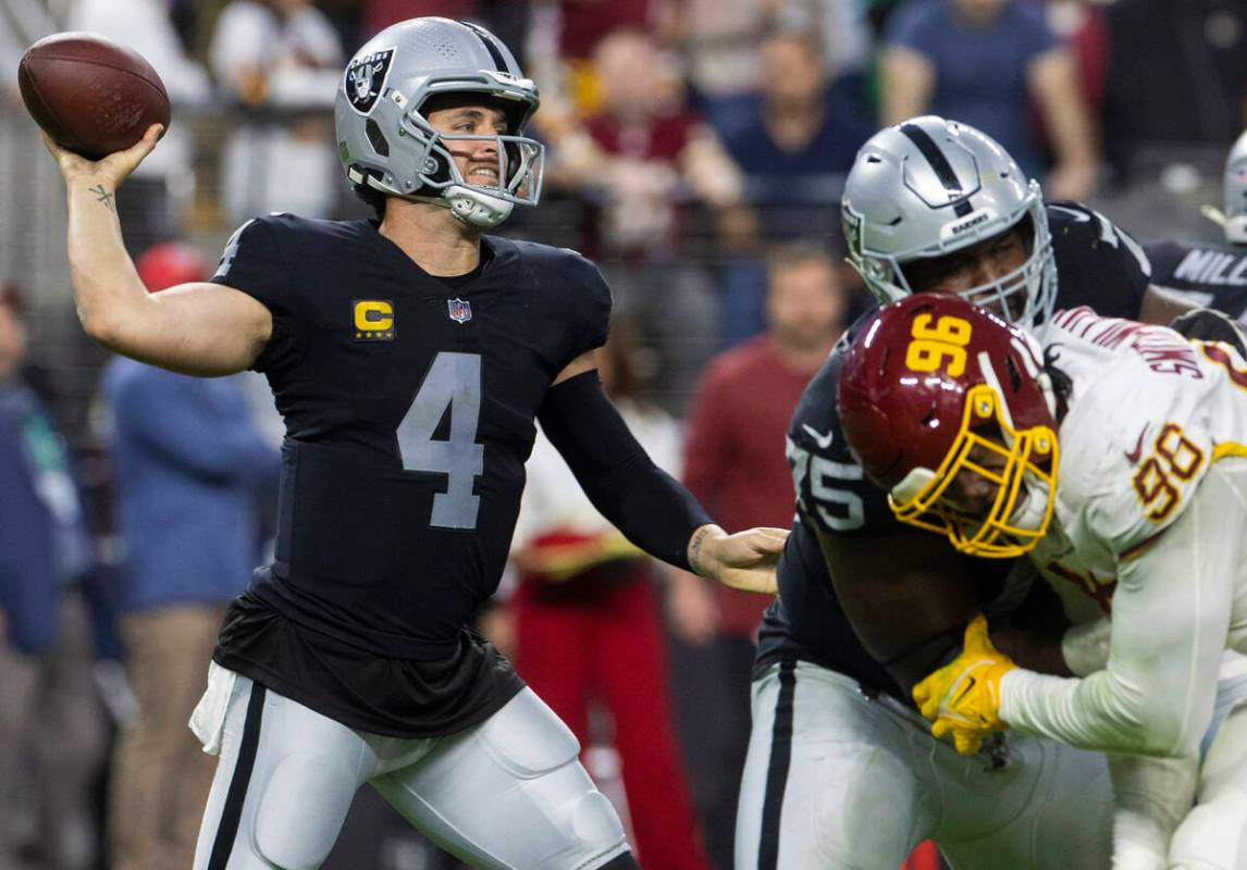 Oakland Raiders quarterback Derek Carr (4) and head coach Jack Del Rio  watch a replay during the second half of an NFL football game against the  San Diego Chargers in Oakland, Calif.