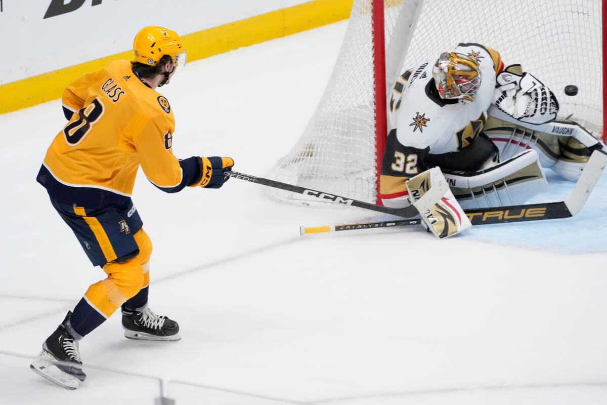 Nashville Predators defenseman Cal Foote (52) passes the puck past Vegas  Golden Knights center Brett Howden (21) during the first period of an NHL  hockey game Tuesday, April 4, 2023, in Nashville