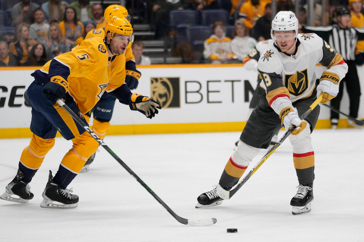 Nashville Predators defenseman Cal Foote (52) passes the puck past Vegas  Golden Knights center Brett Howden (21) during the first period of an NHL  hockey game Tuesday, April 4, 2023, in Nashville