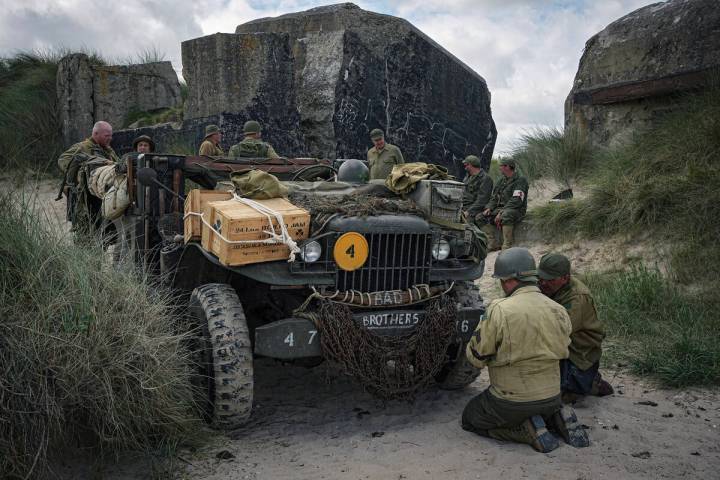 Reenactors fix their car near a bunker during the ceremonies marking the 80th anniversary of D- ...
