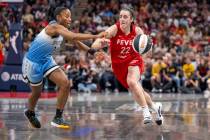 Indiana Fever guard Caitlin Clark (22) makes a move around the defense of Chicago Sky guard Lin ...