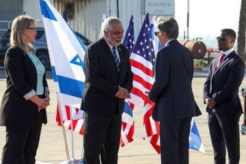 U.S. Secretary of State Antony Blinken, second right, greets an Israeli official upon his arriv ...