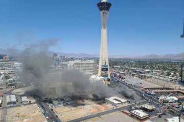 Smoke rises on the Strip from a building fire just south of the Strat around 1 p.m. Wednesday, ...